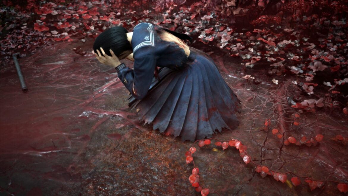 Hinako holds her head in her hand as she lays on the ground surrounded by red plants.