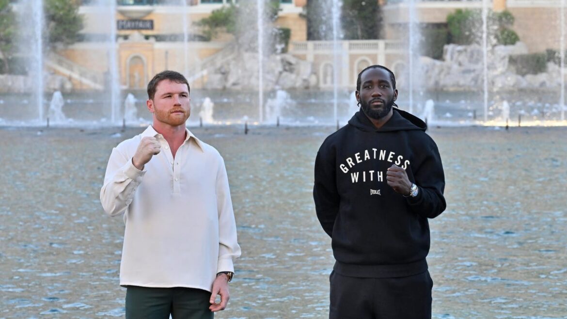 canelo alvarez and terence crawford pose with raised fists