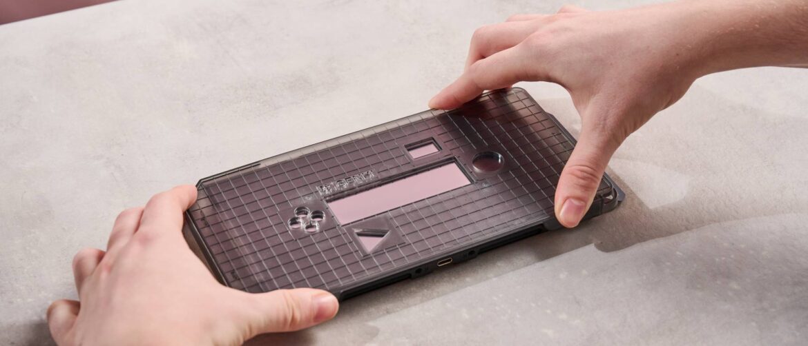 Genki Aegis Shield review: a Nintendo Switch 2 screen protector Person holding application frame on the Genki Aegis Shield