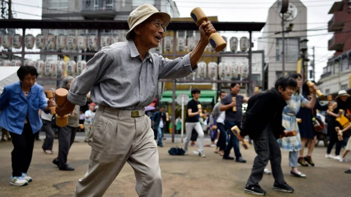 Two women use their smartphones while wearing kimono in Japan.