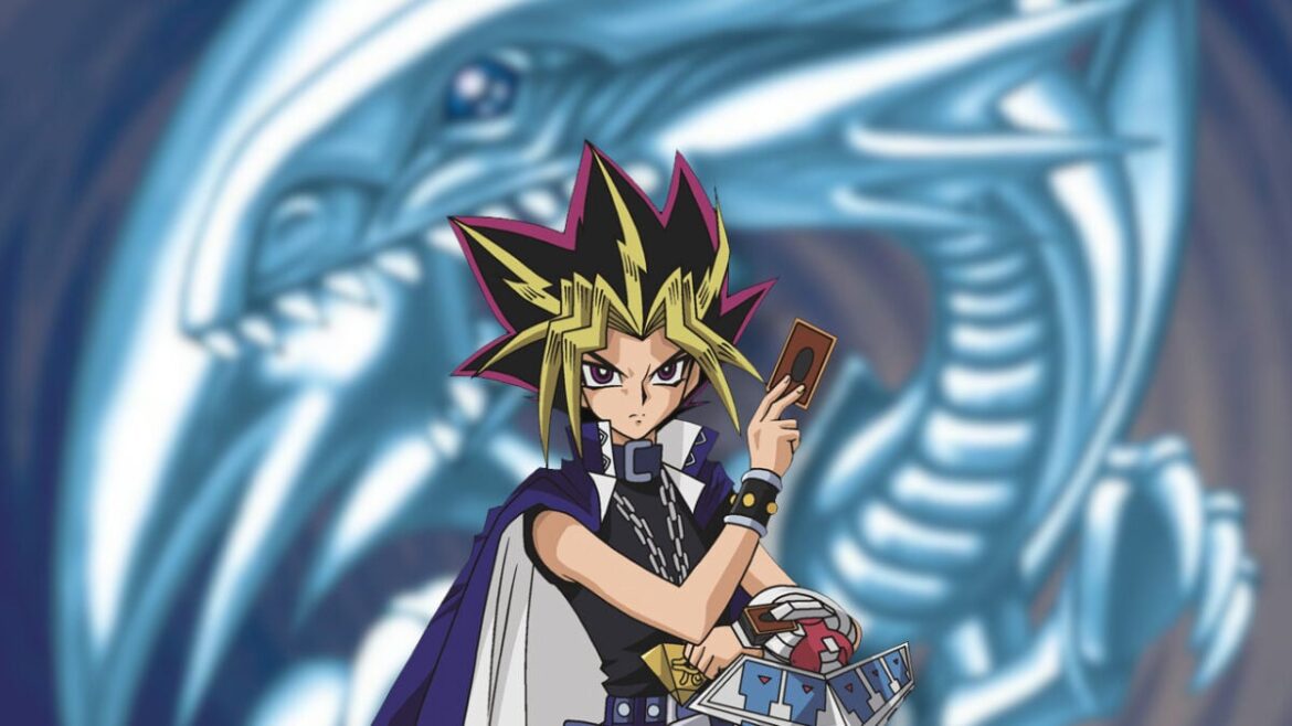 The protagonist of Yu-Gi-Oh holds a card while a blurred image of a dragon makes up the backdrop.