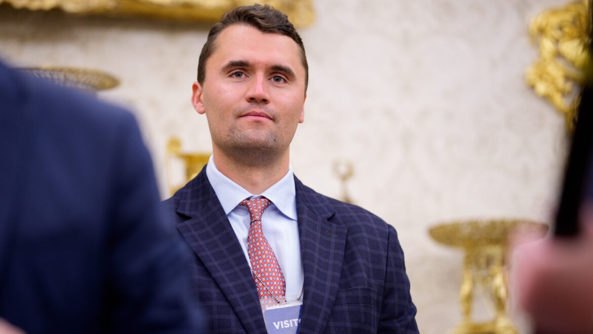 WASHINGTON, DC - MAY 28: Turning Point USA co-founder Charlie Kirk stands in the back of the room as U.S. President Donald Trump speaks during a swearing in ceremony for interim U.S. Attorney for Washington, D.C. Jeanine Pirro in the Oval Office of the White House on May 28, 2025 in Washington, DC. Trump has announced Pirro, a former Fox News personality, judge, prosecutor, and politician, after losing support in the Senate for his first choice, Ed Martin, over his views on the January 6, 2021 attack on the U.S. Capitol. (Photo by Andrew Harnik/Getty Images)