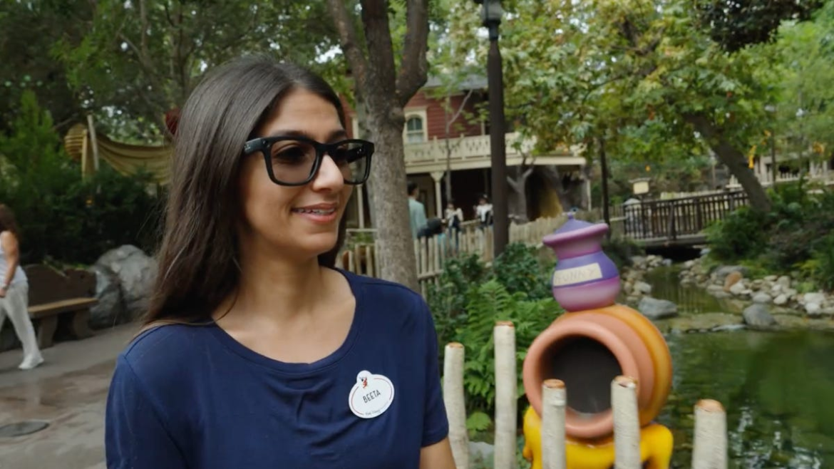 An image showing a Disney Imagineer wearing Meta&apos;s Ray-Ban smart glasses while walking around Disneyland