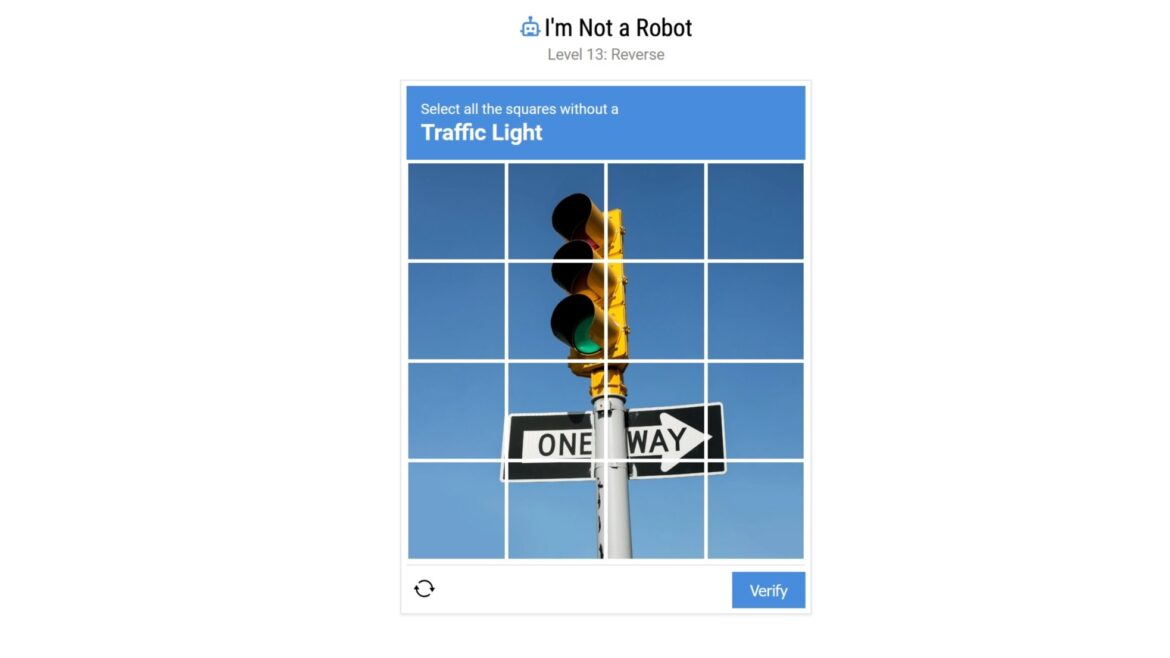 An image of a spoof ReCAPTCHA with text that reads &quot;Select all the squares without a traffic light&quot;.