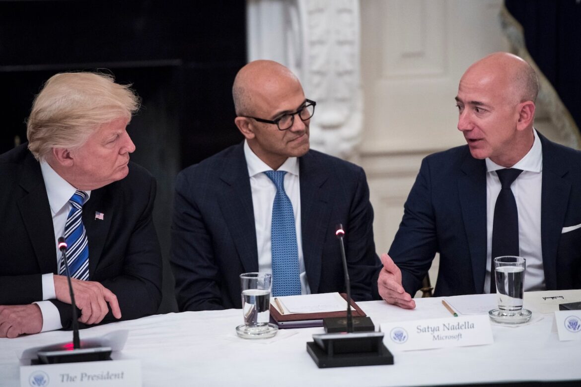 President Donald Trump speaks with Satya Nadella, Chief Executive Officer of Microsoft, and Jeff Bezos, Chief Executive Officer of Amazon during a roundtable at the White House